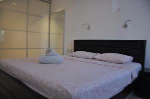 a bedroom with a bed with two pillows on it at Vip Apartment in Bat Yam