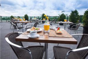 a table with food and drinks on a patio at Hotel Luwansa Palangkaraya in Palangkaraya