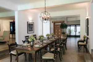 a dining room with a long table and chairs at Boutique Spice Colombo in Colombo