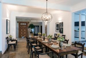 a dining room with a long table and chairs at Boutique Spice Colombo in Colombo