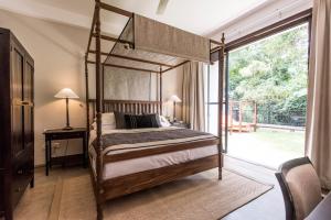a bedroom with a canopy bed and a large window at Boutique Spice Colombo in Colombo +47 photos