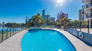 a swimming pool with a city skyline in the background at Silverton Apartment Resort Surfers Paradise in Gold Coast