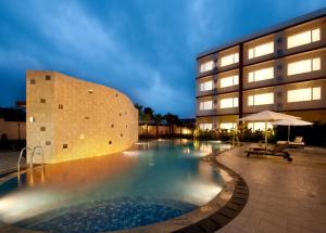 a swimming pool in front of a building at Sancrest Residence Deltamas in Cikarang