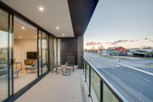 a balcony with a view of a road at Luxury Four Bedroom Apartment with Swimming Pool in Wagga Wagga