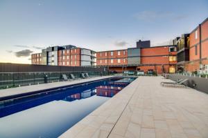a swimming pool on the roof of a building at Luxury Four Bedroom Apartment with Swimming Pool in Wagga Wagga