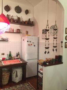 uma cozinha com um frigorífico branco e uma mesa em Lalla's Central Apartment em Tortona