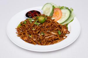 a plate of noodles and vegetables on a white plate at Hotel Seri Malaysia Seremban in Seremban +13 photos