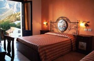 a bedroom with a bed and a large window at Torre Salina in Macari