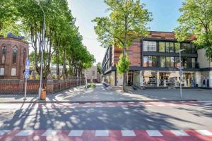 an empty street in a city with a building at IN24 in Palanga