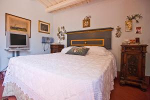 En eller flere senge i et værelse på Baglio Sant'Andrea