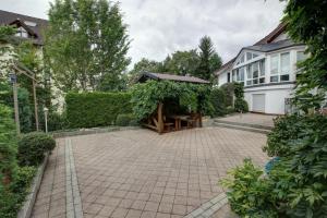 a house with a patio with a gazebo at H41 Inn Hotel Garni Freiburg in Freiburg im Breisgau