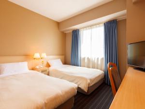 A bed or beds in a room at Hotel Pearl City Akita Kanto-Odori