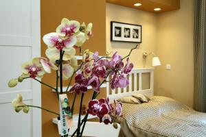 A bed or beds in a room at Orchidea Apartman Eger