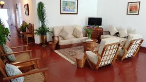 a living room with a couch and chairs at Hatale Tea Estate Bungalow in Madulkele