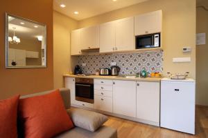 A kitchen or kitchenette at Orchidea Apartman Eger