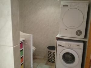 a bathroom with a washing machine and a washer at Mer Golf Esterel in Saint-Raphaël