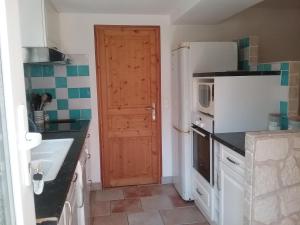 a kitchen with a white refrigerator and a sink at Mer Golf Esterel in Saint-Raphaël