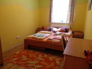 a small bedroom with a bed and a window at Borostyán Vendégház in Kőszeg