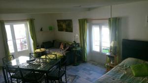 a living room with a couch and a table at Appartement T1 in Dun-les-Places