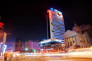 a city at night with a tall building at Ha Luo Hotel in Kunming