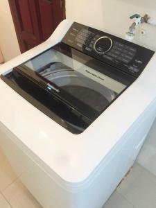 a microwave oven sitting on top of a white counter at Once In Peninsula Guesthouse by Nestcove in Melaka