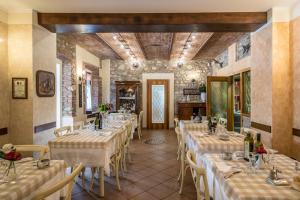 a restaurant with rows of tables in a room at Trattoria Milani in Lonato