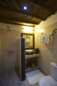 a bathroom with a sink and a toilet and a mirror at Hôtel Kadiandoumagne in Ziguinchor