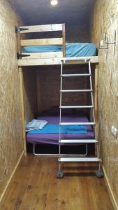 a bunk bed with a ladder in a room at Casa Rosa in Eilat