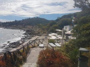 a path leading to a beach with chairs and the ocean at Bordighera Fivestar in Bordighera
