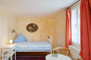 a small bedroom with a bed and a window at Ferienhaus Wagner in Bernkastel-Kues