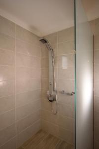 a shower with a shower head in a bathroom at Aristodimos Luxury Apartments in Kalamaki