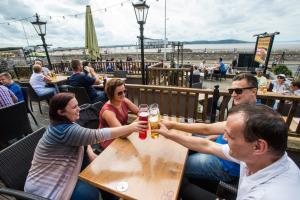 a group of people sitting at a table with drinks at Old Colonial, Weston-Super-Mare by Marston's Inns in Weston-super-Mare +22 photos