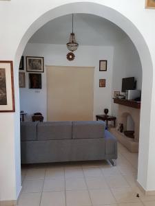 a living room with a couch and an archway at Giorgio Vacation House in Pissouri