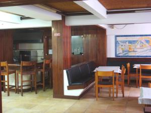 a dining room with a table and some chairs at Residencial Habimar in Sines