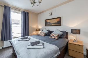 a bedroom with two beds and a window at Watford General Suites in Watford