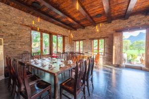 a dining room with a long table and chairs at Rural House in Yangshuo