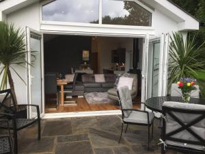a screened in patio with a couch and a table at The Old Rectory in Pencoed
