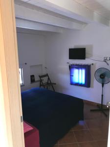 a living room with a tv on the wall at Ort holiday's time in Orco Feglino