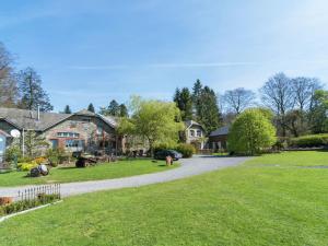 a driveway leading to a yard with houses at Bièvre Forest-Edge Retreat in Bellefontaine