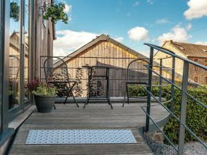 una terraza con sillas y mesas en un edificio en Holiday Home in La Roche en Ardenne with Garden, en Marcouray