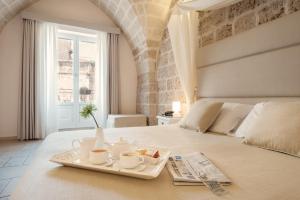 
A bed or beds in a room at Hotel L'Arcangelo - Boutique Hotel
