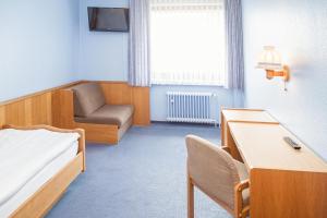 a hospital room with a bed and a chair at Hotel Hannover Airport by Premiere Classe in Hannover