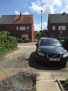 a car parked in the driveway of a house at Holiday Home near town in Aarschot