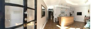 a room with a door to a kitchen and a living room at The Beverley Hotel London - Victoria in London
