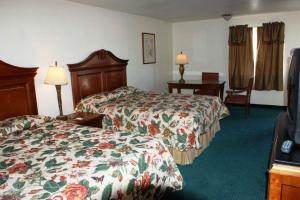 a hotel room with two beds and a television at HWY Express Inn and Suites in Thatcher +22 photos
