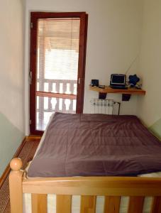 a bed in a room with a window at "Athos"apartment potkrovlje in Višegrad