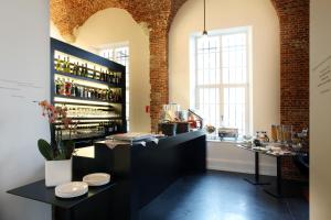 a bar in a room with a shelf of wine bottles at Hotel The Lodge Vilvoorde in Vilvoorde