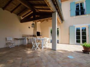 an outdoor kitchen and dining area of a house at Villa Bastide d Or in Campagnan