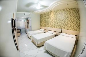 Postel nebo postele na pokoji v ubytování Hotel Tito's