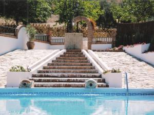 a set of stairs next to a swimming pool at Belvilla by OYO Casa Mi Pepe in Priego de Córdoba